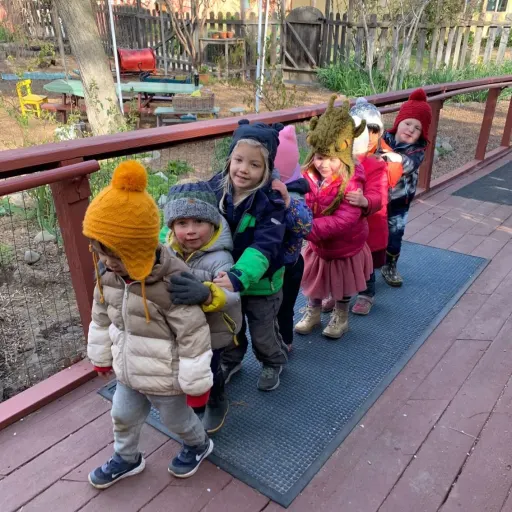 Preschool kids outside in a line playing