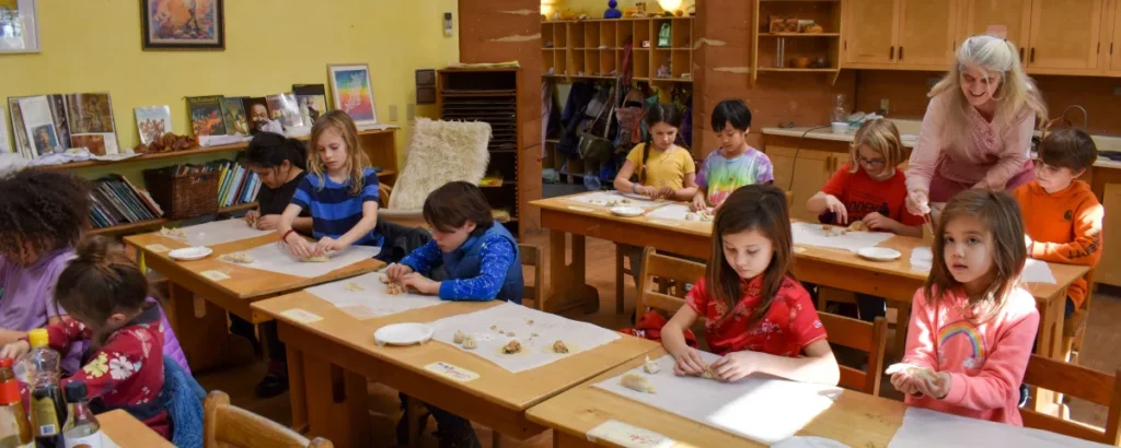 Children sitting at desks writing in books