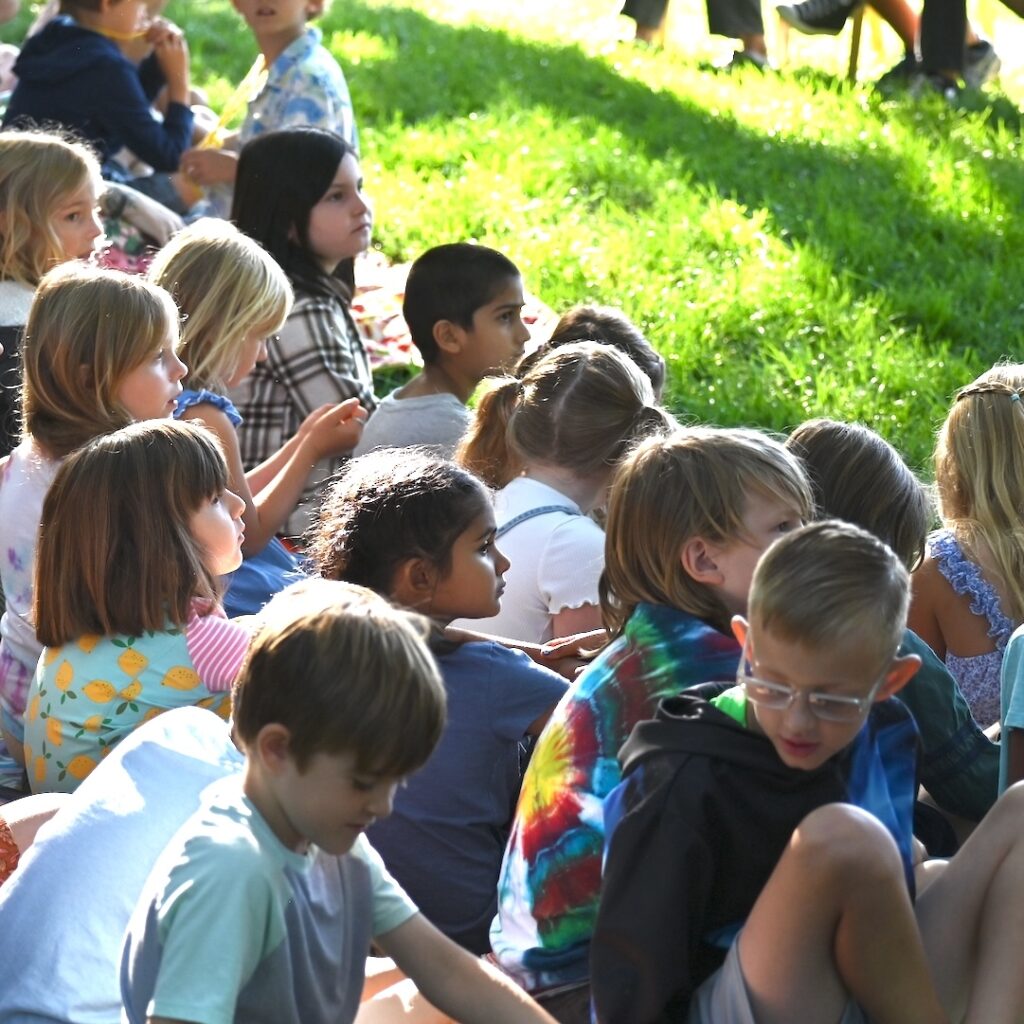 Children sitting together at opening ceremony