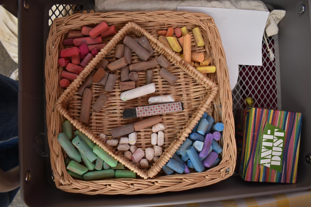 different color chalk in a basket