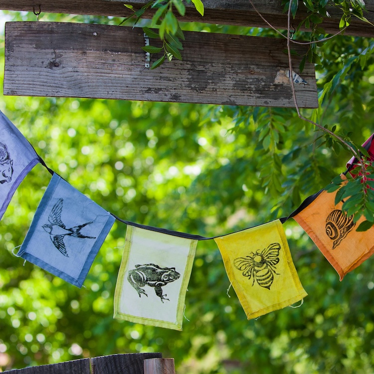 row of flags hanging in the garden