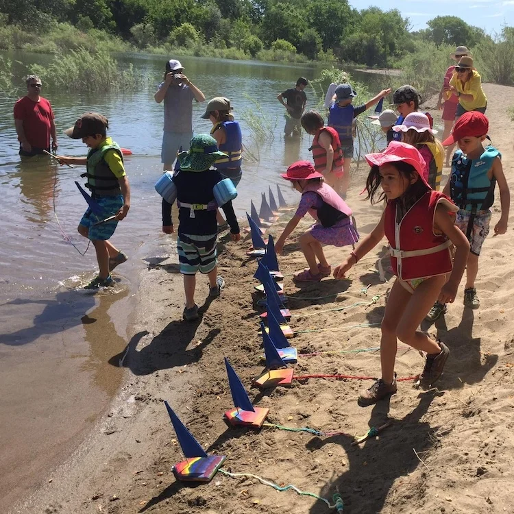 Kids playing on the beach on the river for boating day