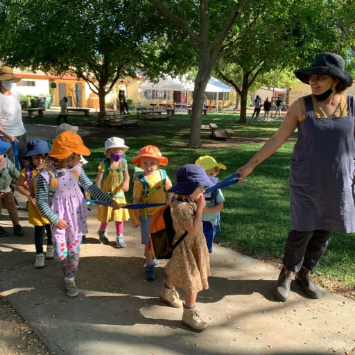 kids outside in a line following the teacher