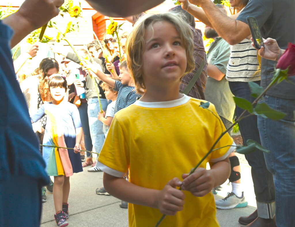 Smiling young boy in yellow shirt looking up